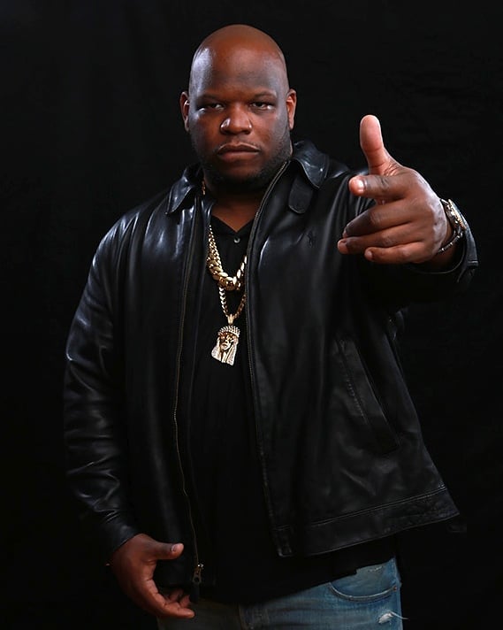 Meyhem Lauren in a black leather jacket and blue jeans.